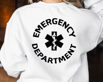 Może przedstawiać: Biała bluza z czarnym kołem graficznym z tyłu. Grafika zawiera napis "Emergency Department" z symbolem medycznym w środku.