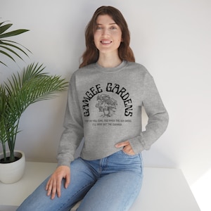 May include: A gray sweatshirt with a black graphic print of a tree and the text "Grangee Gardens" in a retro font. The text below the graphic reads "Hey dat will come, and when the sun shines it'll shine out the clearer."
