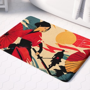 May include: A red and black bath mat with a woman in a red kimono and a man in black standing in front of a red sun. The mat has a Japanese-inspired design with red and black umbrellas.