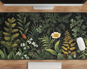 May include: A black desk mat with a floral pattern featuring green leaves, white flowers, and a red butterfly. The mat is on a wooden surface with a white keyboard and a white mouse.