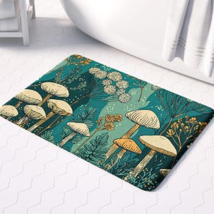 May include: A rectangular bath mat featuring a whimsical mushroom design. The mat showcases cream-colored mushroom caps with tan stems against a teal and green background. Botanical elements in yellow and green complete the nature-inspired design.