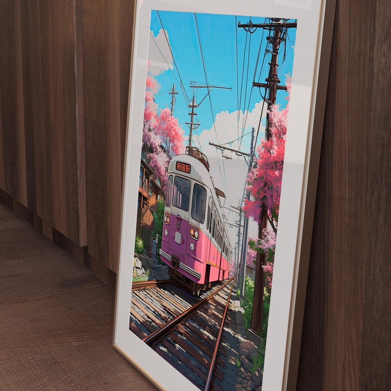 May include: A pink and white train with the Japanese text "都電荒川線" on the side, traveling along a track with cherry blossoms in the background.