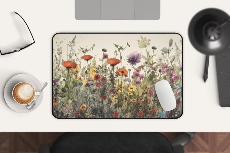 May include: A colorful floral design mousepad with a variety of flowers in shades of red, orange, yellow, pink, and purple. The flowers are arranged in a row across the bottom of the mousepad, with a light brown background.