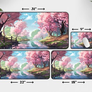 May include: Four different sizes of mouse pads featuring a digital illustration of a river flowing through a forest with pink cherry blossom trees. The largest mouse pad is 31 inches by 15.5 inches, the next largest is 22 inches by 12 inches, the next is 18 inches by 12 inches, and the smallest is 9 inches by 7 inches.