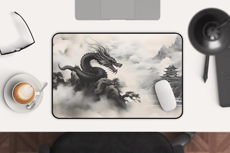 May include: A black and white mousepad with a dragon flying over a mountain range and a pagoda in the background. The dragon is in a cloud of smoke and the mountain range is covered in fog.