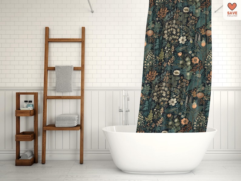 May include: A white bathtub with a shower curtain featuring a dark blue and green floral pattern. The shower curtain has a variety of flowers and leaves in shades of orange, yellow, and white. The bathroom has white subway tile walls and a wooden ladder shelf.