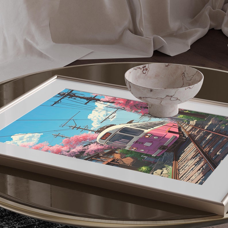 May include: A framed print of a pink and white train traveling through a Japanese city with cherry blossom trees in bloom.