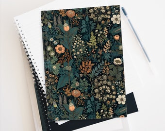 May include: A black notebook with a floral pattern featuring a variety of flowers in shades of orange, white, and green. The flowers are arranged in a repeating pattern on a dark background.