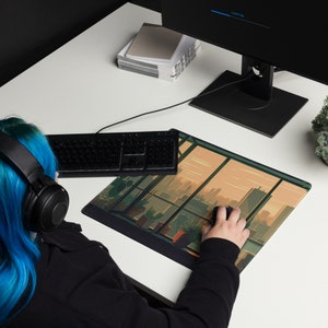 May include: A person using a computer with a city skyline mousepad. The mousepad features a window view with a cityscape and a sunset sky. The mousepad is on a white desk with a keyboard and a computer monitor.