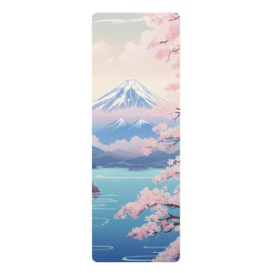 May include: A scenic illustration of Mount Fuji with a lake in the foreground and a cherry blossom tree in the right corner. The sky is a soft pink and blue with white clouds.