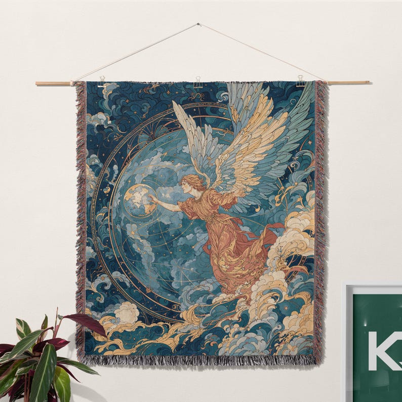 May include: A woven tapestry featuring an angel with large wings, reaching towards a globe. The artwork is in shades of blue, gold, and peach, with a celestial theme. The tapestry is hung from a wooden rod.