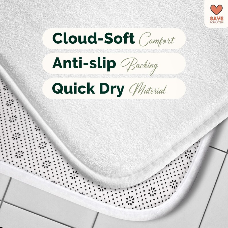 May include: Close-up of a white bath mat with a soft, textured surface. The mat features text that reads "Cloud-Soft Comfort", "Anti-slip Backing", and "Quick Dry Material". The bottom layer has a black and white floral pattern.