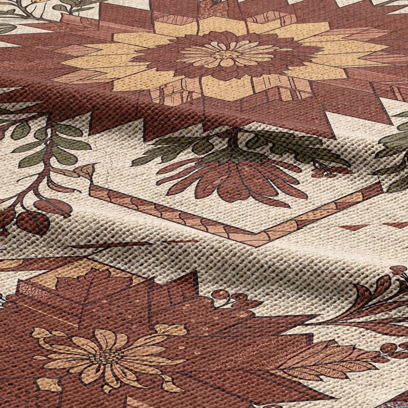 Puede incluir: Primer plano de un textil estampado con un dise&ntilde;o floral en tonos marr&oacute;n, beige y verde. La tela tiene un aspecto texturizado con un patr&oacute;n geom&eacute;trico y bot&aacute;nico repetitivo. El dise&ntilde;o incluye flores y hojas estilizadas.