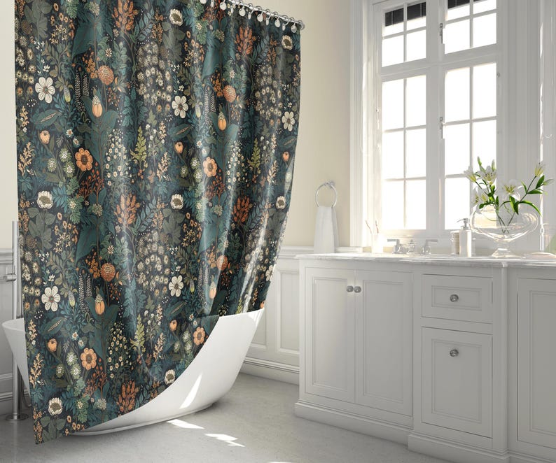 May include: A teal shower curtain with a floral pattern featuring various shades of green, brown, and orange. The curtain is hung in a bathroom with a white bathtub and white cabinets.