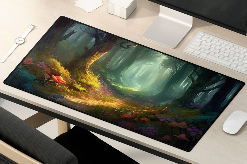 May include: A black and green mousepad with a fantasy forest scene. The scene features a path leading into a forest with tall trees and a misty atmosphere. The path is lined with colorful flowers and mushrooms.