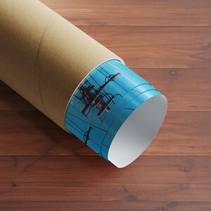 May include: A rolled up poster tube with a blue and white design featuring a silhouette of a person working on a power line. The tube is made of cardboard and has a brown exterior.