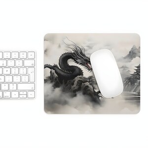 May include: A black dragon with red eyes is depicted in a traditional Japanese style, flying over a mountain range with a pagoda in the background. The design is on a light gray mouse pad.