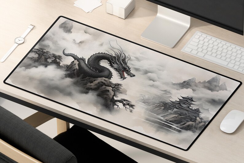 May include: A black and white mousepad with a dragon and mountain scene. The dragon is flying through the clouds and the mountains are in the background.