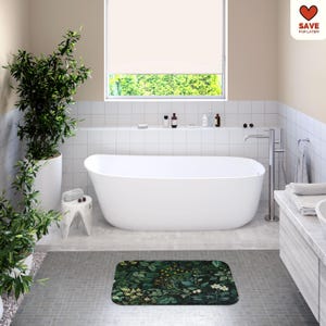 May include: A modern bathroom with a white oval bathtub, a green floral bath mat, and a large window. The room features white tile walls, a small stool, and a potted plant. The text "SAVE FOR LATER" is in the upper right corner.