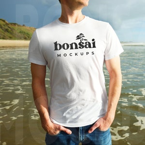 Men&#39;s White T-shirt Mockup | 3001 Bella Canvas White Shirt Mockup with Male Model | Pacific Ocean Beach Background