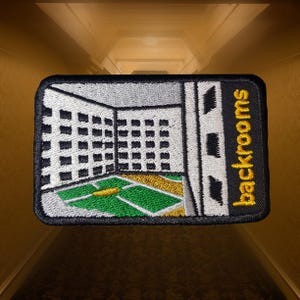 May include: Embroidered patch featuring a stylized interior scene with a green and yellow floor, white walls, and a grid pattern. The patch has the word "backrooms" in yellow text on a black background.