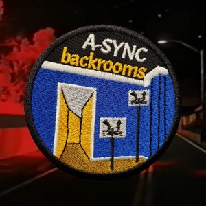 May include: Embroidered patch with a circular design featuring the text "A-SYNC backrooms." The patch has a black border, a blue background, and a yellow and gray interior design. Two black and white signs are also visible.