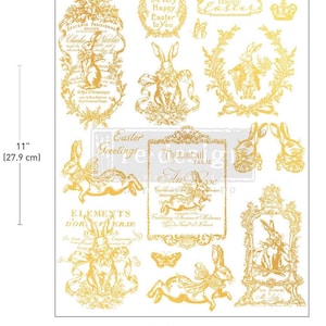 May include: A sheet of gold-colored Easter-themed decorative transfers. The sheet is 8.5 inches wide (21.5 cm) and 11 inches tall (27.9 cm). Designs include rabbits, floral wreaths, butterflies, and text such as "Happy Easter".