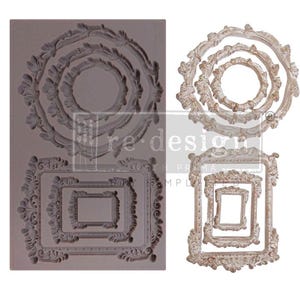 May include: A gray silicone mold with ornate frame designs and the text "re design with prima". The mold features circular and rectangular frames in various sizes, perfect for crafting and DIY projects.