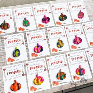 May include: A collection of colorful pumpkin-shaped crayons on cards. Each card reads "You're the best pumpkin in the patch!" in a decorative font. The crayons are various colors, including orange, green, pink, and yellow.