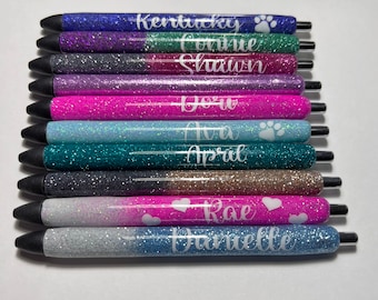 May include: A set of 10 glitter pens with personalized names, including Kentucky, Connie, Shaunn, Dora, Ava, April, Rae, and Danielle. Some pens have a paw print or heart design.