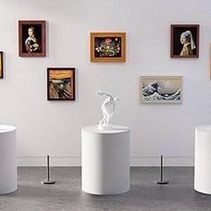 May include: A gallery display featuring three white cylindrical pedestals, each supporting a white sculpture. The wall behind displays seven framed art prints, including depictions of famous paintings like The Scream and The Great Wave off Kanagawa.