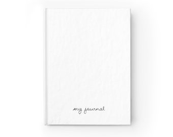 May include: A white journal with the text "my journal" written in black ink on the front cover.