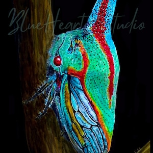 May include: A watercolor painting of a brightly colored Oak Treehopper, platycostis vittata, perched on a branch. The insect has a vibrant green, blue, yellow, and red pattern.