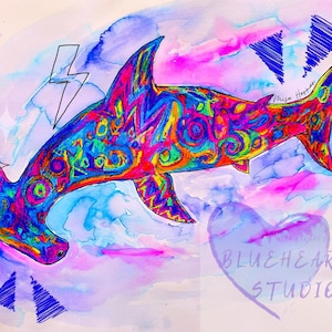 May include: A colorful watercolor painting of a hammerhead shark with a psychedelic pattern. The shark is swimming in a blue and pink watercolor background. The painting is signed "Vanya Harper" and includes the text "BLUEHEARTS STUDIO".
