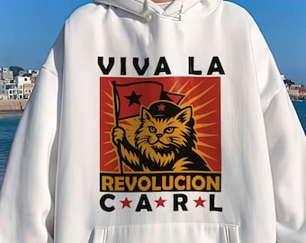 May include: White hoodie with a front pocket and drawstring. The front features a graphic of a cat holding a flag with the text "VIVA LA REVOLUCION CAR*R*L" in black and red. The hoodie has ribbed cuffs and a relaxed fit.