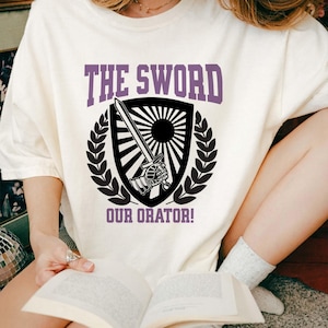 May include: A handmade wooden sign with the text "Welcome" in a playful font. The sign is painted white with a distressed finish, and features a decorative floral design in shades of pink and green. It measures approximately 12 inches wide.