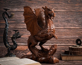May include: A wooden dragon sculpture with intricate details, standing on a wooden base. The dragon has outstretched wings and a fierce expression.