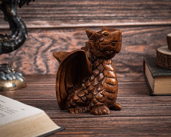 A hand-sculpted baby dragon with articulated wings — 105 favorites don't lie, this is the kind of desk sculpture people stop and pick up.