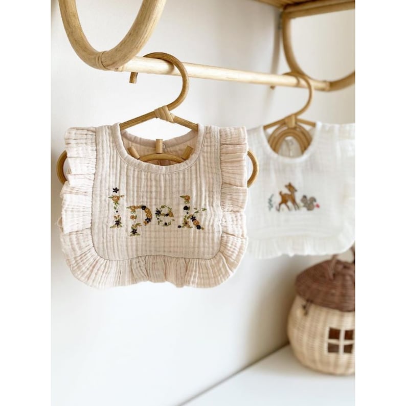 Elevate your little one's dining experience with this beautifully crafted personalized muslin bib, adorned with hand embroidery.