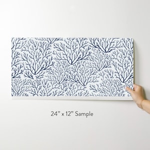 May include: A sample of wallpaper featuring a repeating pattern of navy blue coral branches on a white background. The sample measures 24 inches by 12 inches.