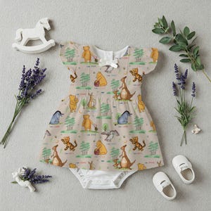 May include: A beige baby onesie with a Winnie the Pooh and friends print. The onesie features a variety of characters including Winnie the Pooh, Tigger, Piglet, Eeyore, and Roo. The onesie has a white trim around the neckline and sleeves.