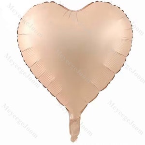 Puede incluir: Un globo de coraz&oacute;n de aluminio de color melocot&oacute;n claro.