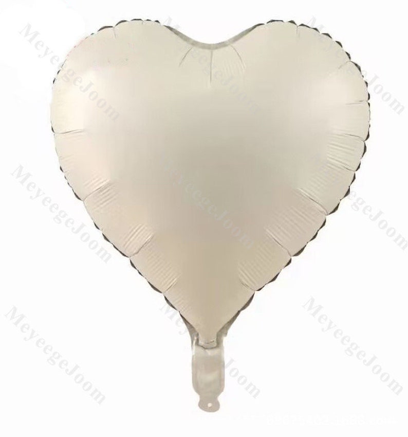 Puede incluir: Un globo de coraz&oacute;n blanco de aluminio.