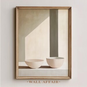 May include: A framed abstract painting featuring two light pink bowls on a gray surface. The background has a neutral color palette with a vertical gray stripe and a light-filled area. The text "WALL AFFAIR" is at the bottom.