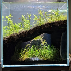 May include: A set of three ceramic mugs with a speckled, matte finish. The mugs are in shades of cream, light gray, and dark gray. Each mug has a simple, minimalist design, perfect for coffee or tea.