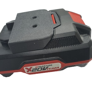 Peut inclure: Batterie d'outil électrique noire et rouge avec le texte "Parkside X20V Team" sur le côté.