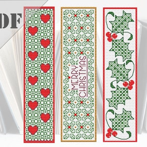 May include: Three cross-stitch bookmark patterns featuring a red heart design, a green and red snowflake design with the text "Merry Christmas", and a green holly design with red berries.
