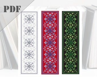 May include: Three cross-stitch bookmark patterns featuring geometric designs. The bookmarks are in white, red, and black with blue, green, and gray accents.