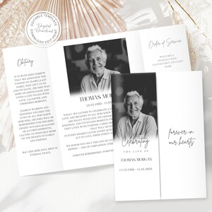 May include: A white tri-fold memorial card with a black and white photo of a smiling person. The card includes text such as "Obituary", "Celebrating the Life of", and "forever in our hearts". The dates 13.12.1950 - 11.01.2025 are also visible.