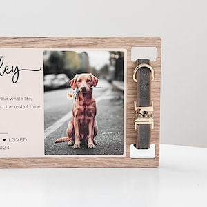 May include: Wooden memorial plaque with a photo of a golden retriever dog holding a flower in its mouth. The plaque has the text "[Name]" and "You were my whole life, you were the rest of mine."  The plaque also includes a dog collar with a gold buckle.
